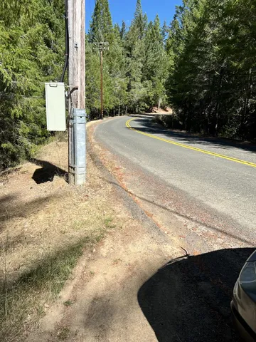 a view of a street with yard