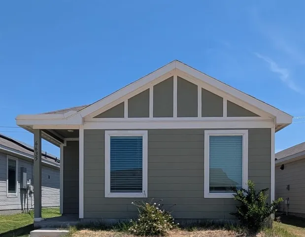 a front view of a house with garden