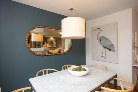 a dining room with a table and chairs