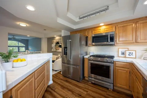 a kitchen with a sink stove and refrigerator