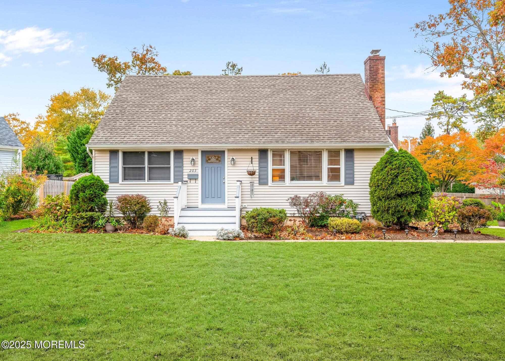 a front view of house with a garden and patio