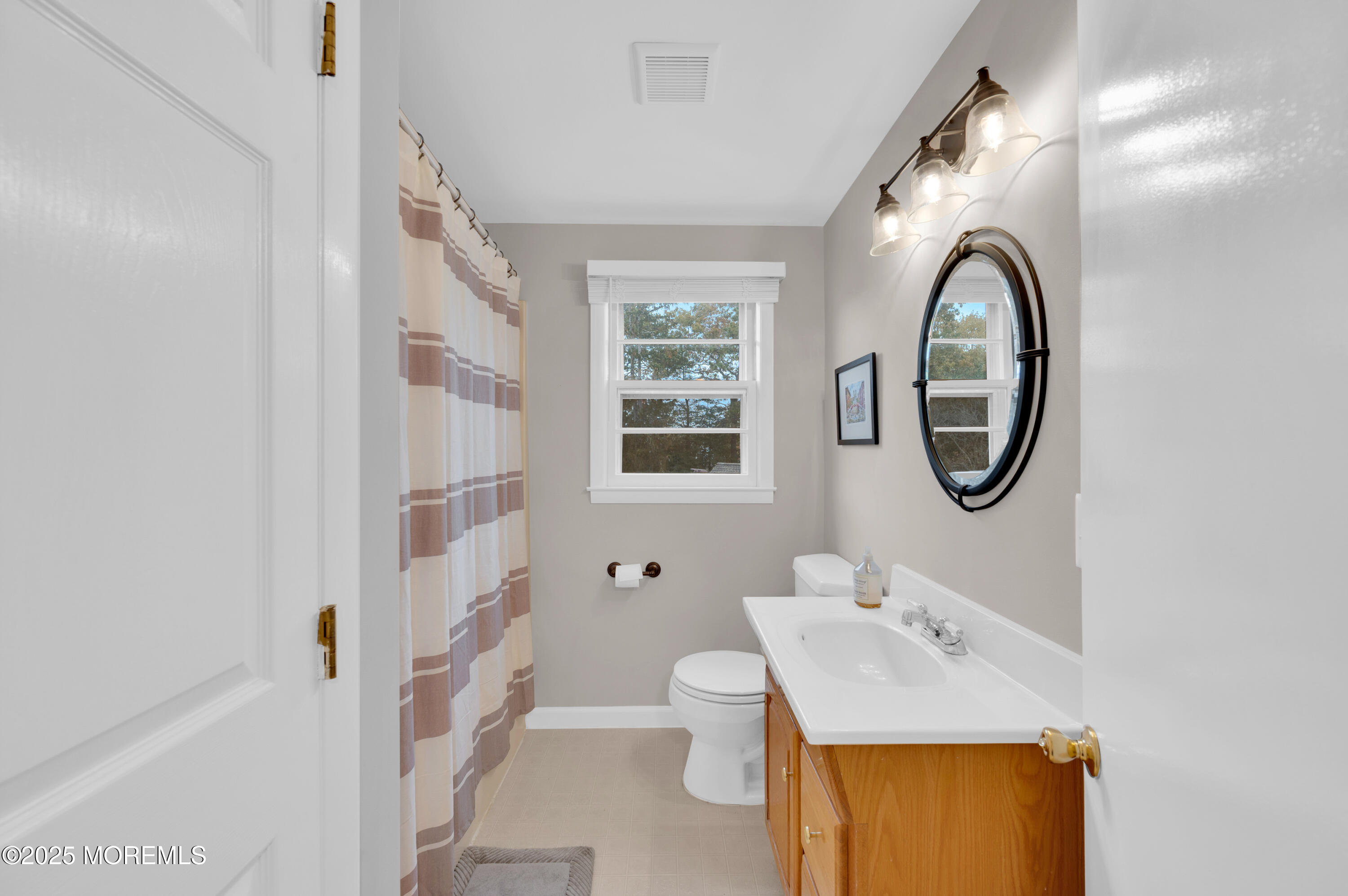 203 Lenape Trail Brielle, NJ 08730 - Photo 14 of 29 a bathroom with a sink toilet and a mirror