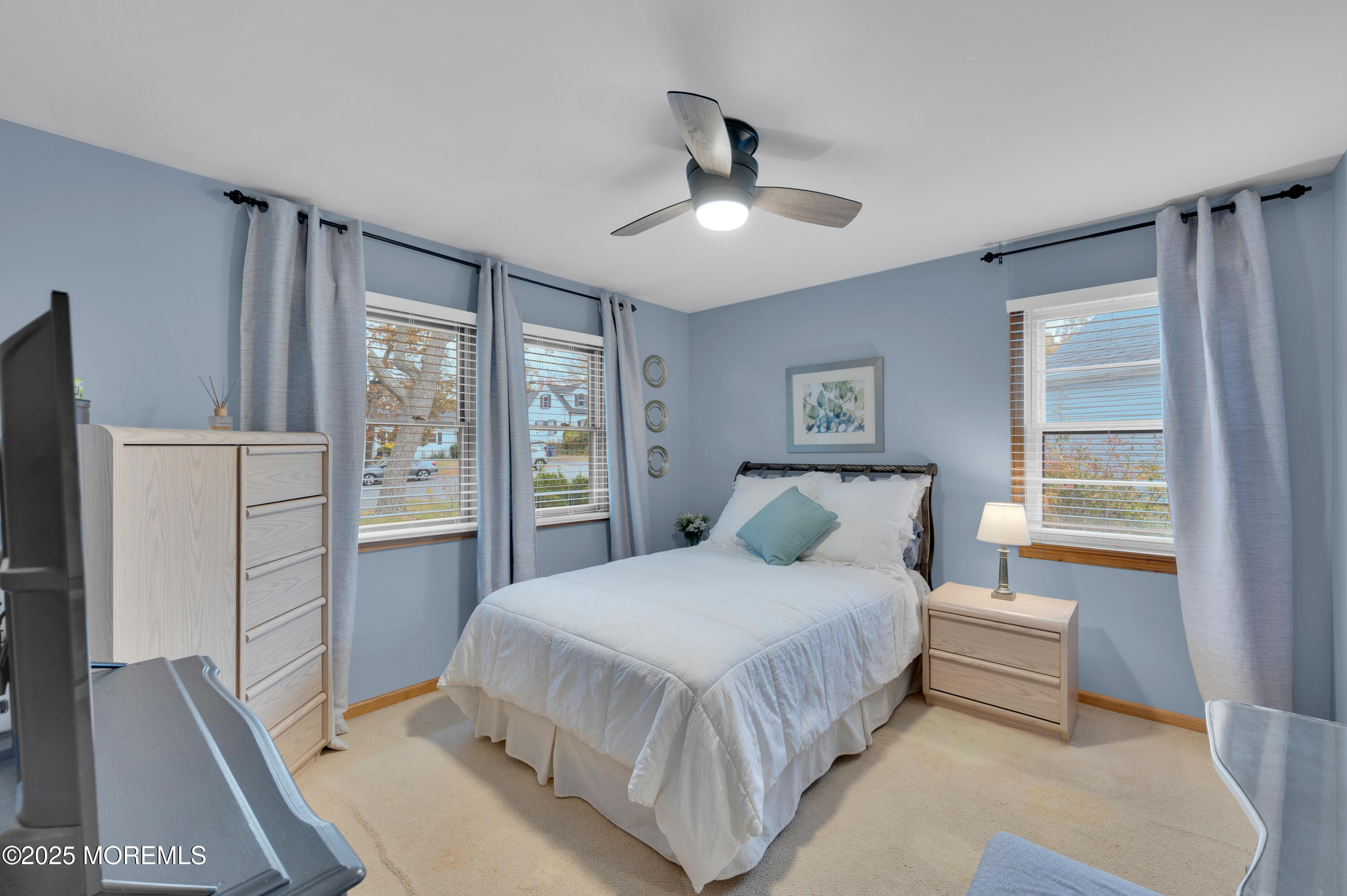 203 Lenape Trail Brielle, NJ 08730 - Photo 15 of 29 a bedroom with a large bed and a chandelier