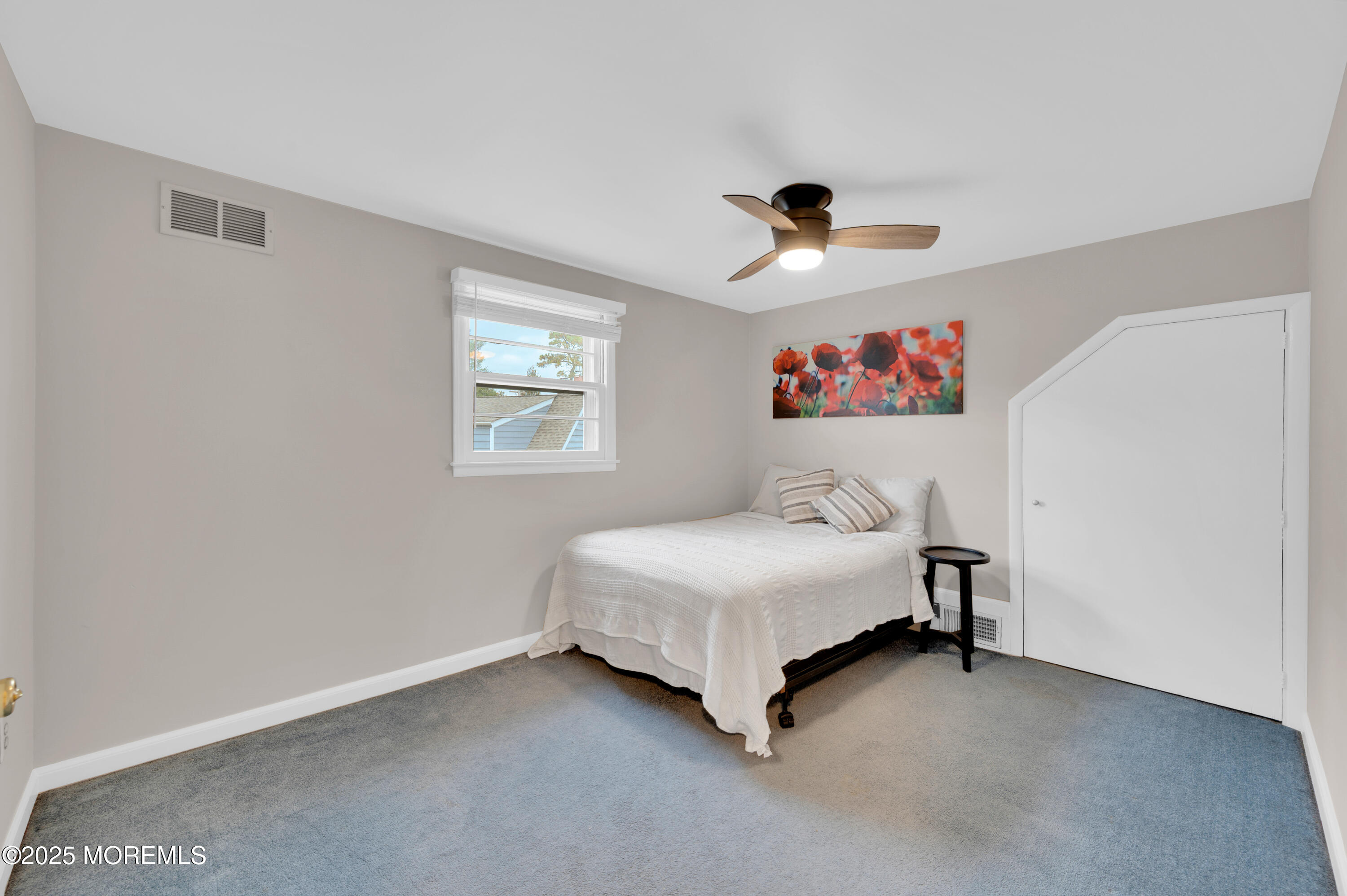 203 Lenape Trail Brielle, NJ 08730 - Photo 19 of 29 a bedroom with a bed and a chandelier