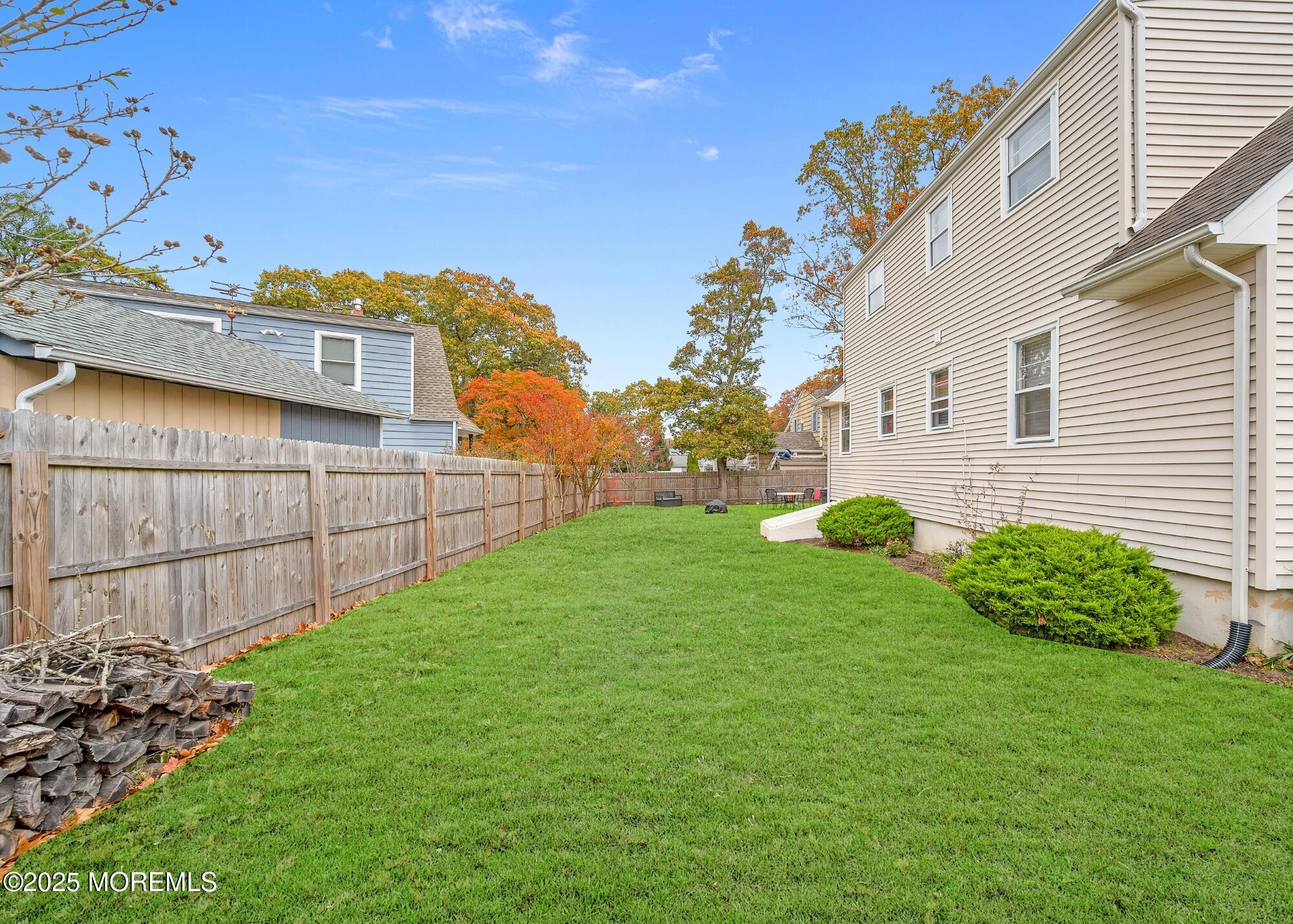 203 Lenape Trail Brielle, NJ 08730 - Photo 22 of 29 a view of a backyard with plants and brick wall