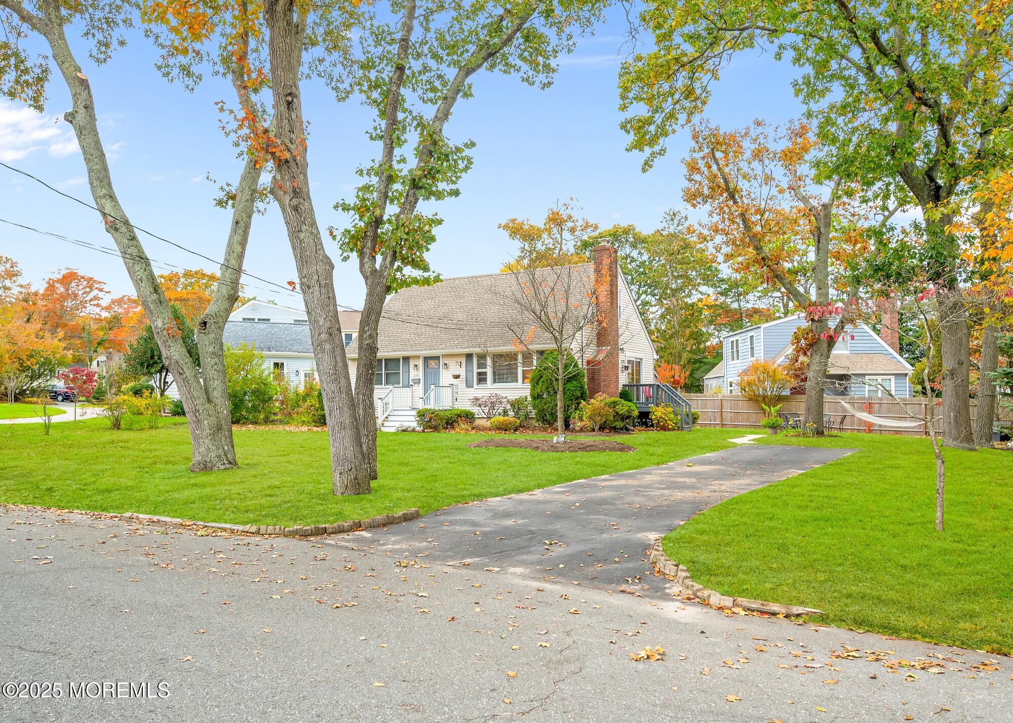 203 Lenape Trail Brielle, NJ 08730 - Photo 3 of 29 a view of a big house with a big yard and large trees