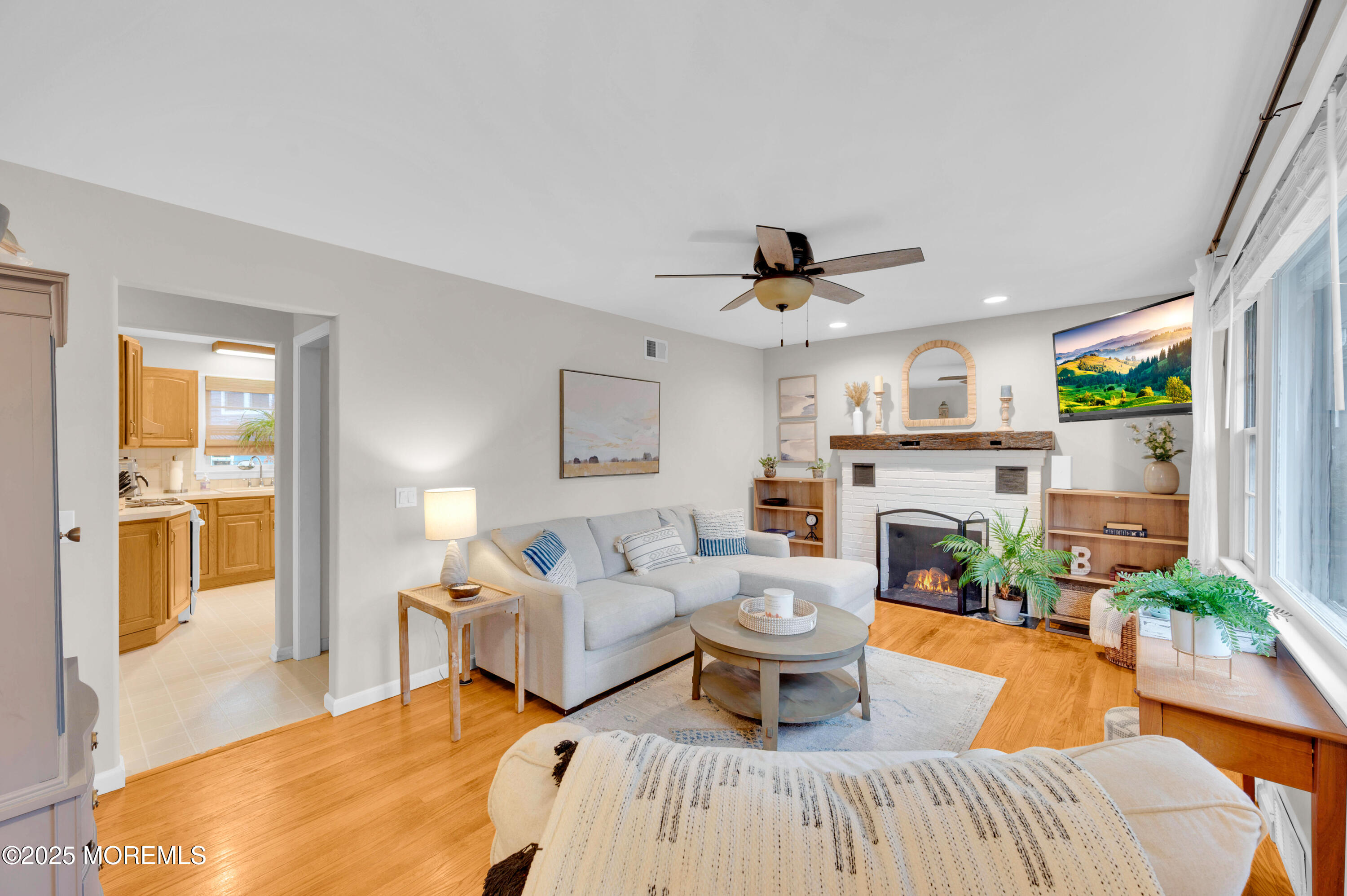 203 Lenape Trail Brielle, NJ 08730 - Photo 7 of 29 a living room with furniture a fireplace and a large window
