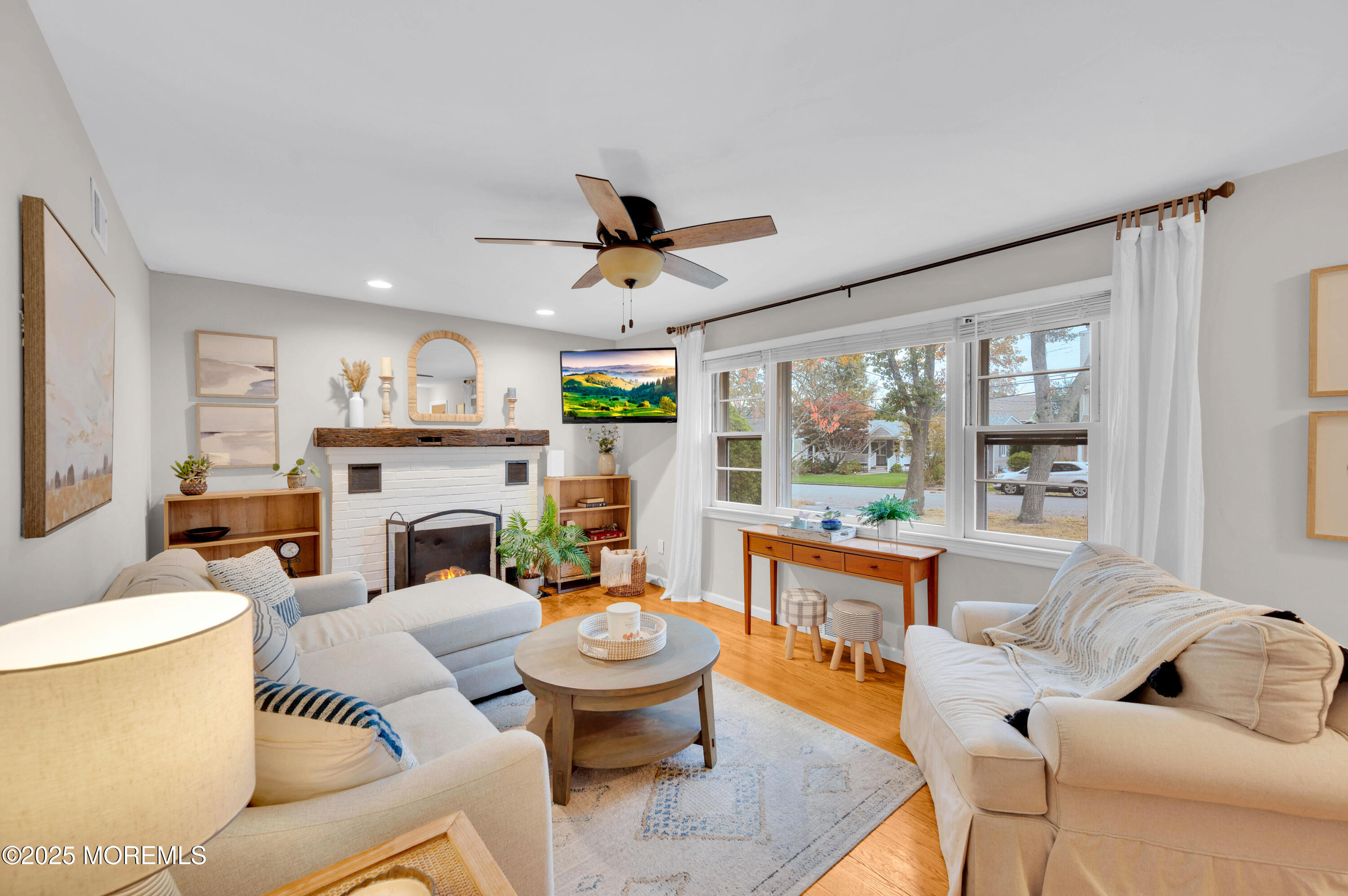 203 Lenape Trail Brielle, NJ 08730 - Photo 8 of 29 a living room with furniture fireplace and a large window