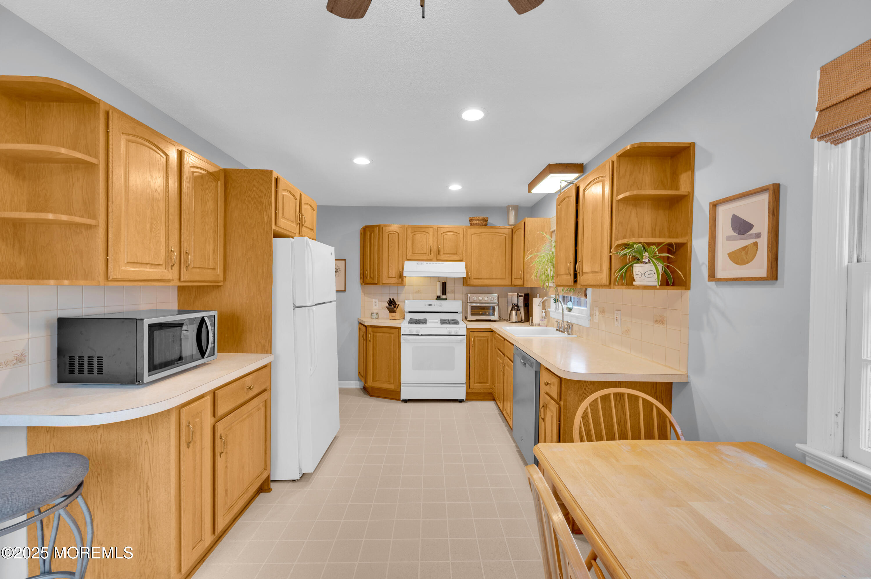 203 Lenape Trail Brielle, NJ 08730 - Photo 9 of 29 a kitchen with stainless steel appliances a stove a sink a microwave and a refrigerator
