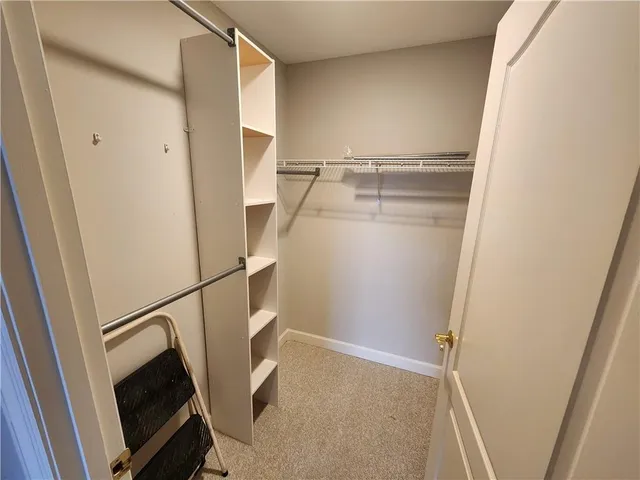 a living room with furniture and a large mirror