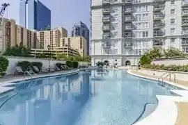 a front view of a house with a yard and fountain