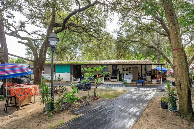 a patio with a table and chairs under an umbrella