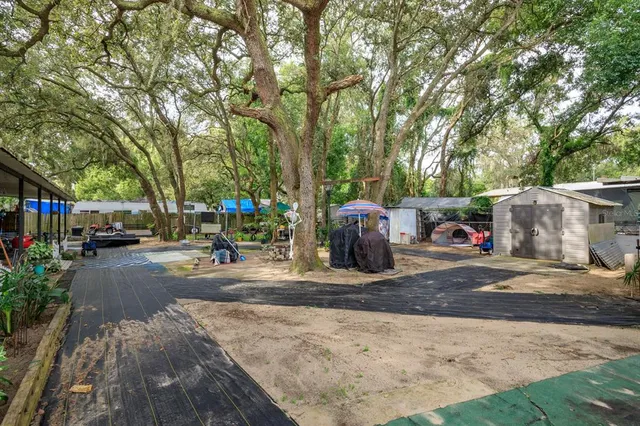 a view of a patio with a table and chairs under an umbrella