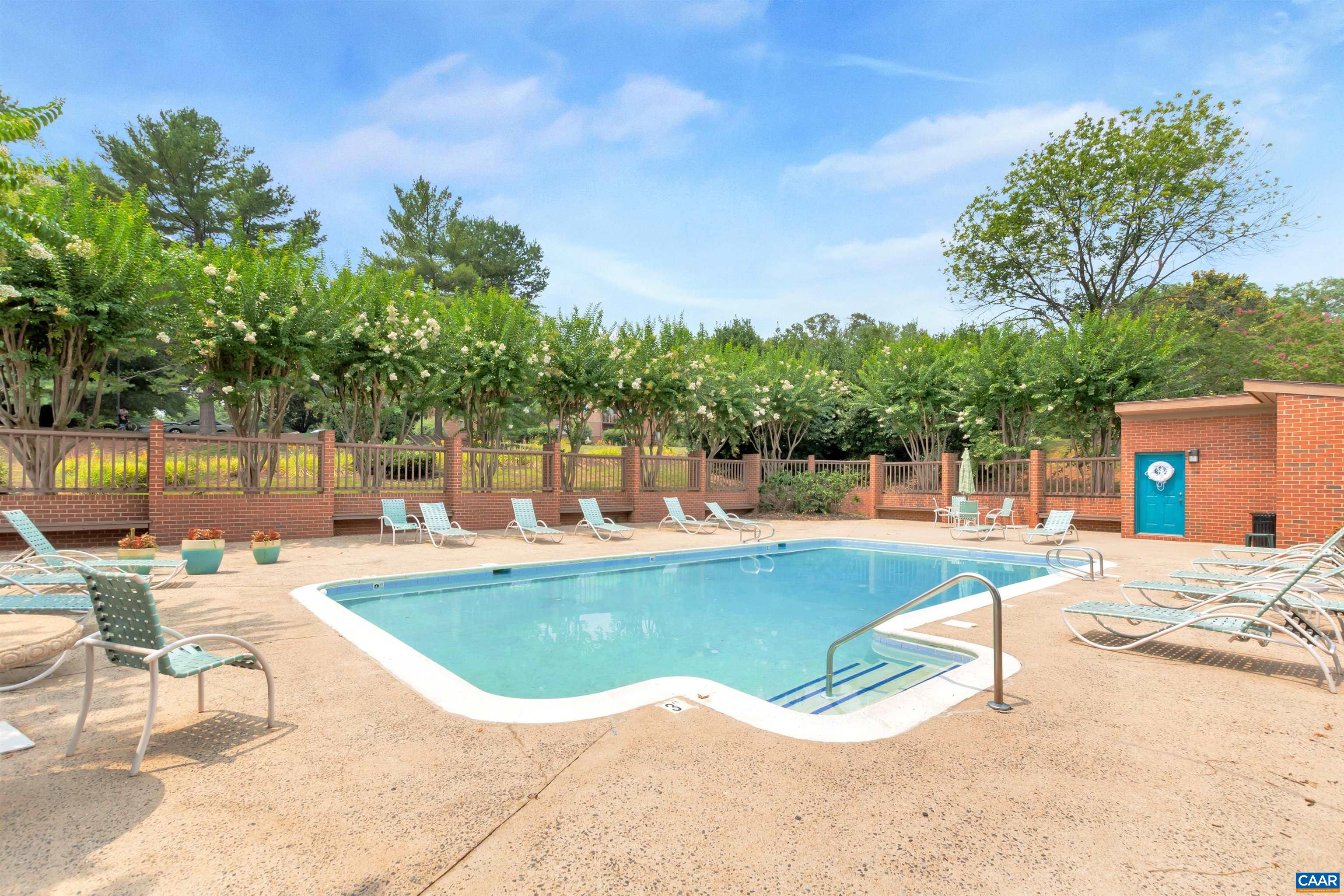 114 Turtle Creek Road, Unit 4 Charlottesville, VA 22901 - Photo 31 of 41 a view of a swimming pool with lawn chairs under an umbrella