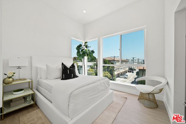a bedroom with a bed and a potted plant