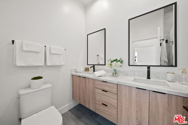 a bathroom with a double vanity sink and a mirror