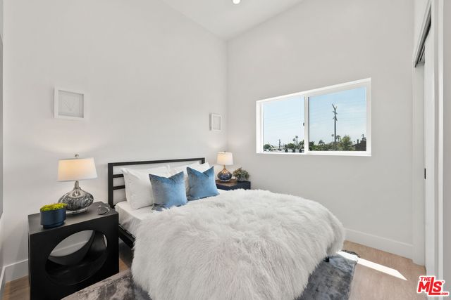 a bedroom with a bed and wall painting