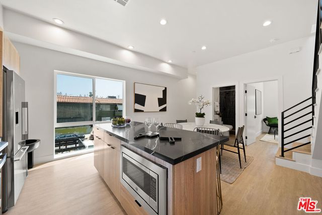 a kitchen with stainless steel appliances granite countertop a stove and a sink