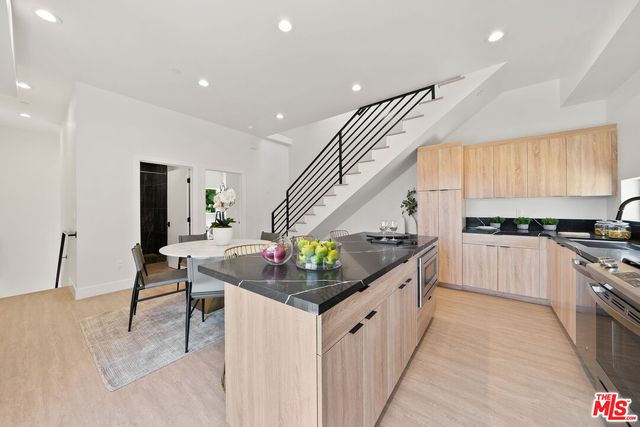 a kitchen with stainless steel appliances and white cabinets