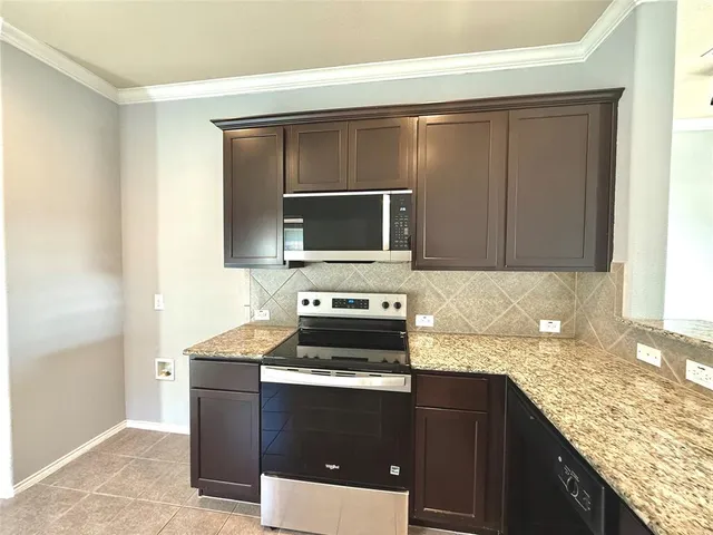 a kitchen with granite countertop a sink and cabinets