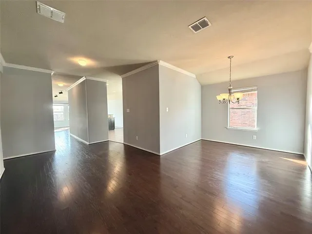 a view of a room with wooden floor and windows