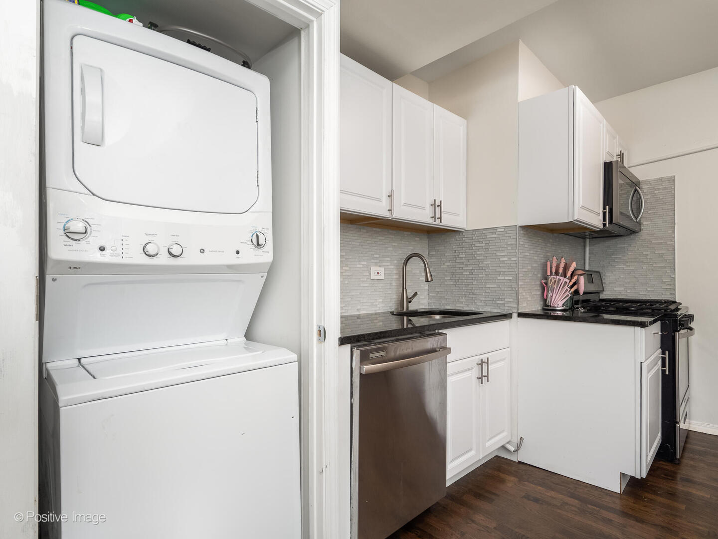 4101 West Iowa Street, Unit 6 Chicago, IL 60651 - Photo 12 of 16 a kitchen with stainless steel appliances granite countertop a sink and a stove