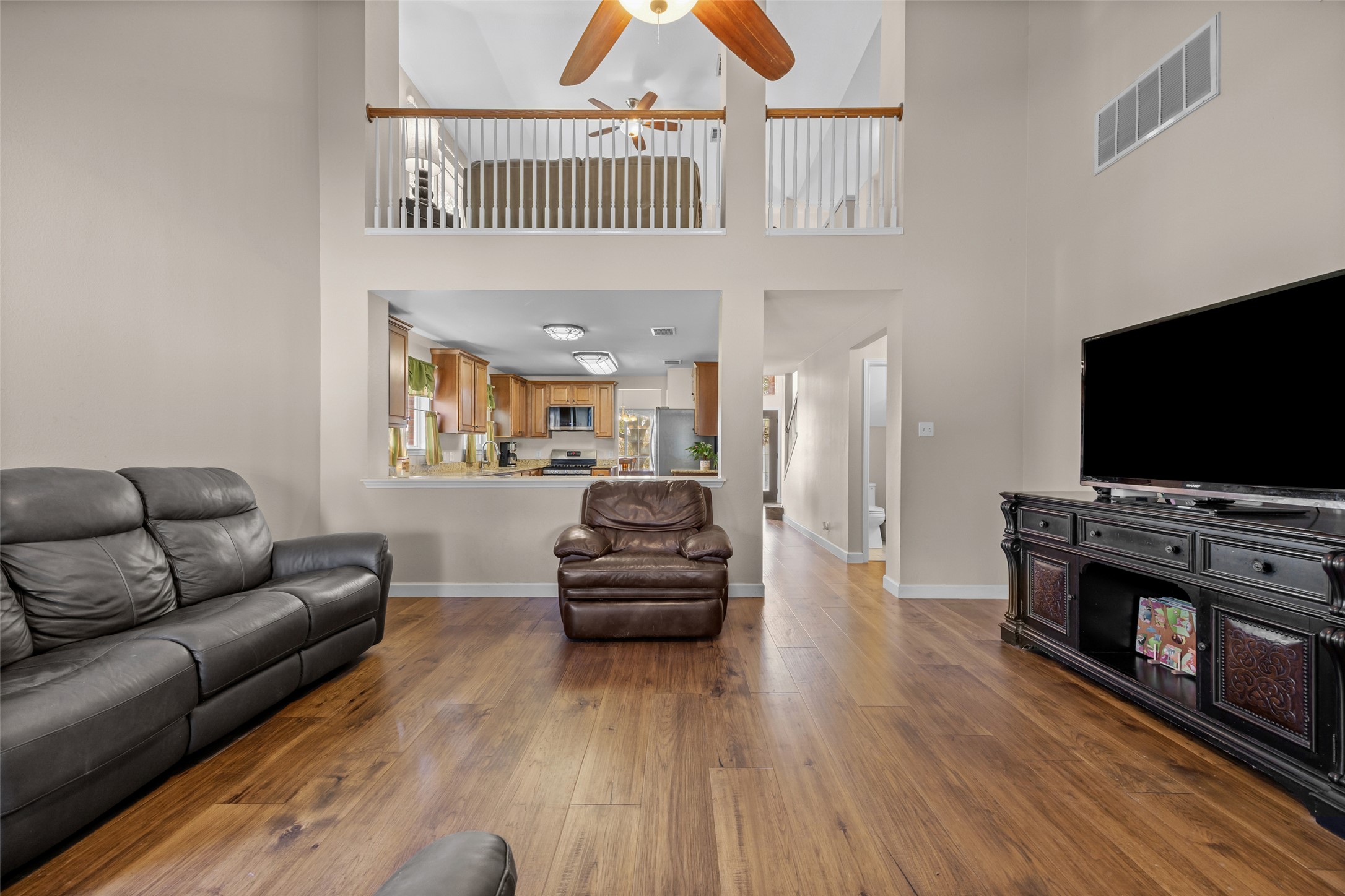 15918 Two Rivers Cove Austin, TX 78717 - Photo 10 of 30 Large family room with high vaulted ceilings, open to the kitchen and views of the backyard.