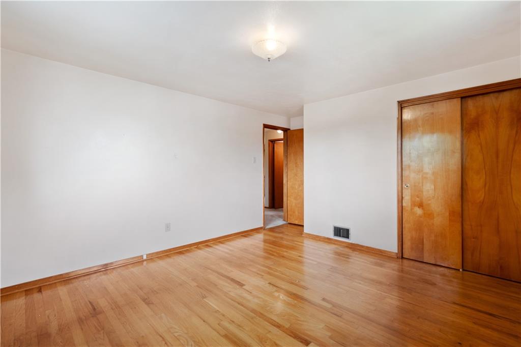 77 Observatory Street Manor, PA 15665 - Photo 16 of 25 an empty room with wooden floor and windows
