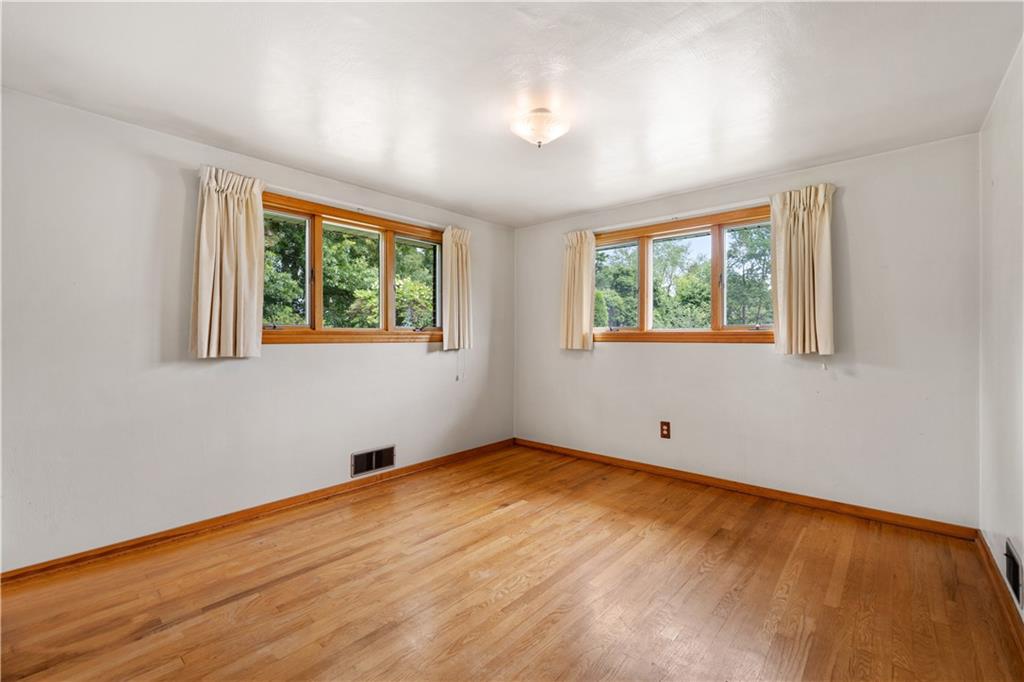 77 Observatory Street Manor, PA 15665 - Photo 17 of 25 a view of an empty room with wooden floor and a window