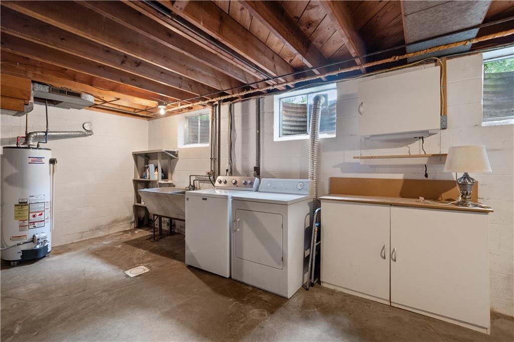 77 Observatory Street Manor, PA 15665 - Photo 22 of 25 a utility room with cabinets dryer and washer