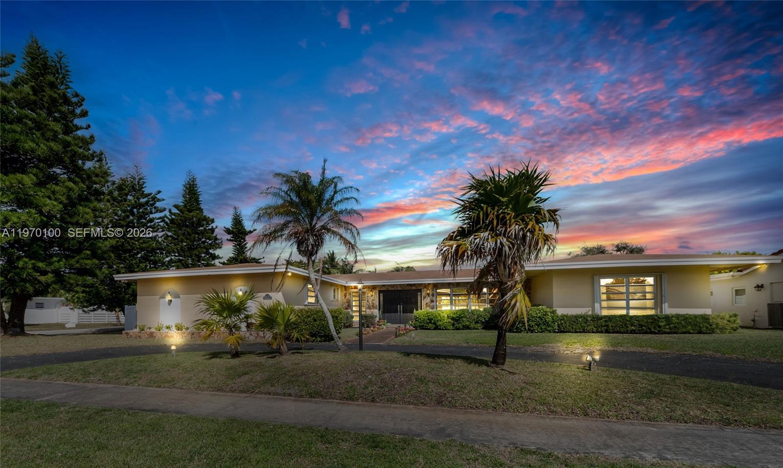 4931 Madison Street Hollywood, FL 33021 - Photo 1 of 26 a front view of a house with a yard