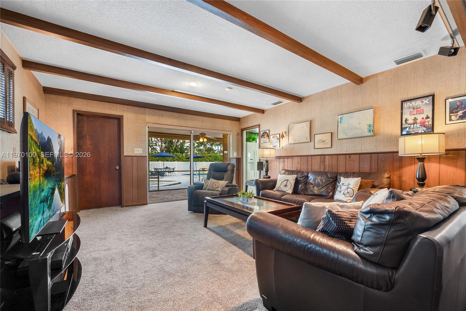 4931 Madison Street Hollywood, FL 33021 - Photo 12 of 26 a living room with furniture a window and a flat screen tv