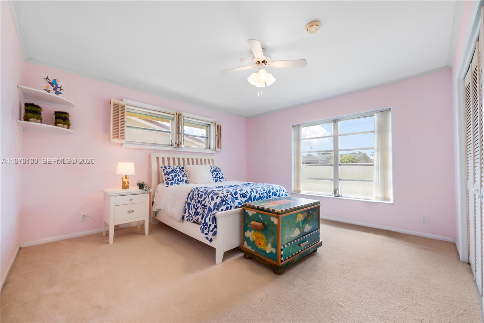 4931 Madison Street Hollywood, FL 33021 - Photo 13 of 26 a bedroom with a bed and a chandelier