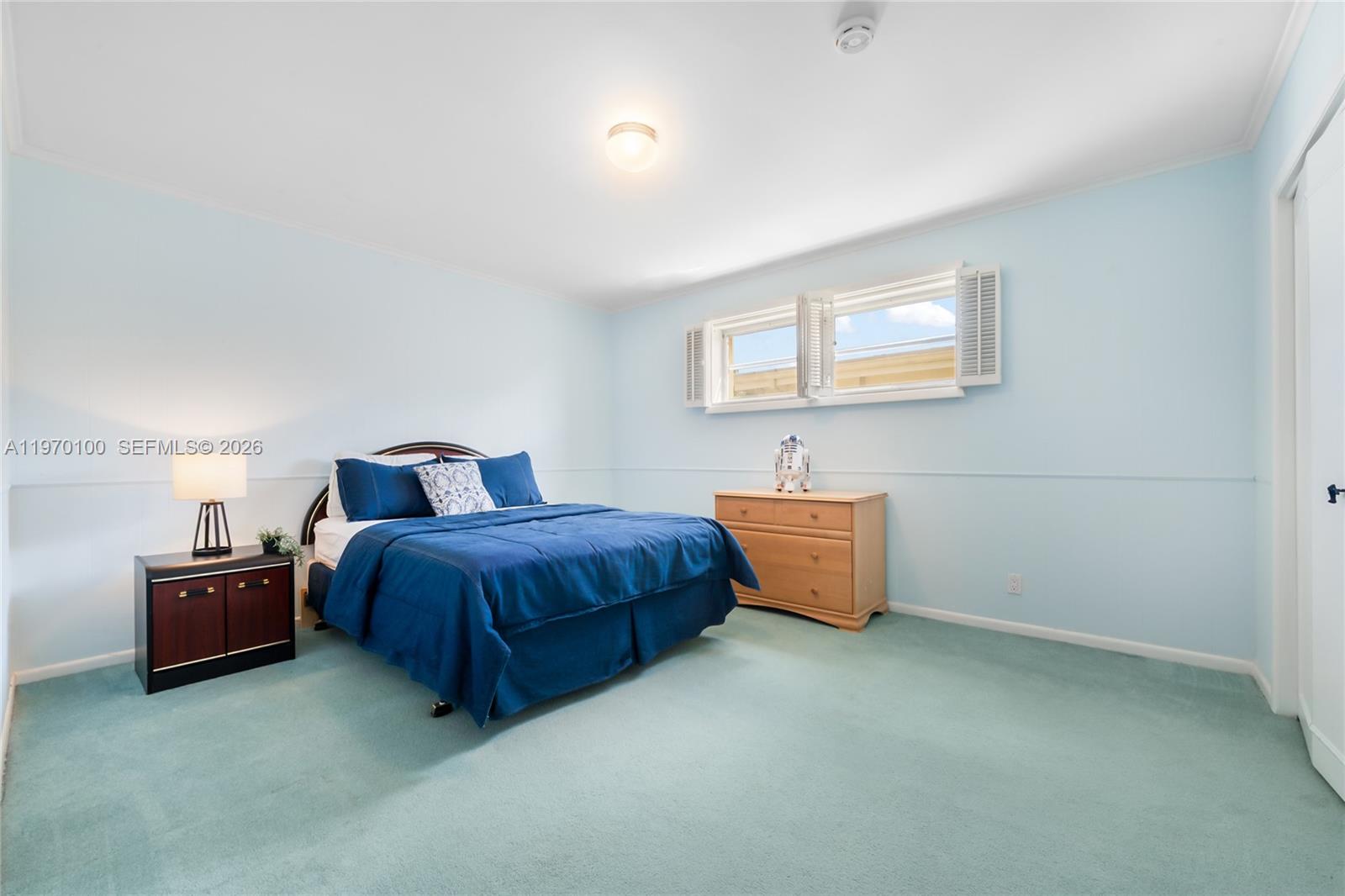 4931 Madison Street Hollywood, FL 33021 - Photo 15 of 26 a spacious bedroom with a bed and dresser