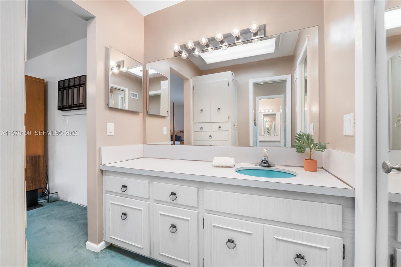4931 Madison Street Hollywood, FL 33021 - Photo 19 of 26 a bathroom with a sink double vanity and a mirror