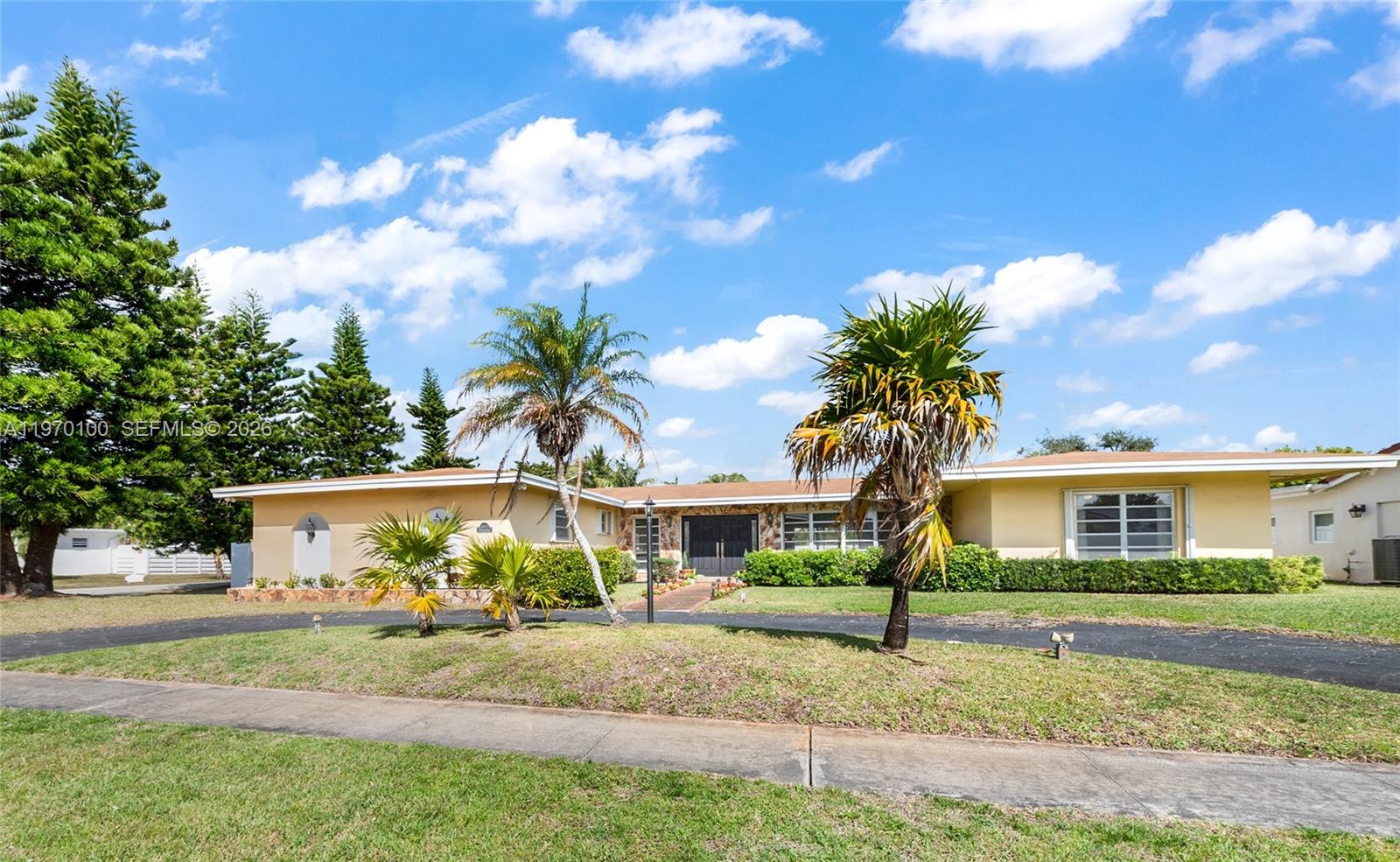 4931 Madison Street Hollywood, FL 33021 - Photo 2 of 26 front view of house with a yard