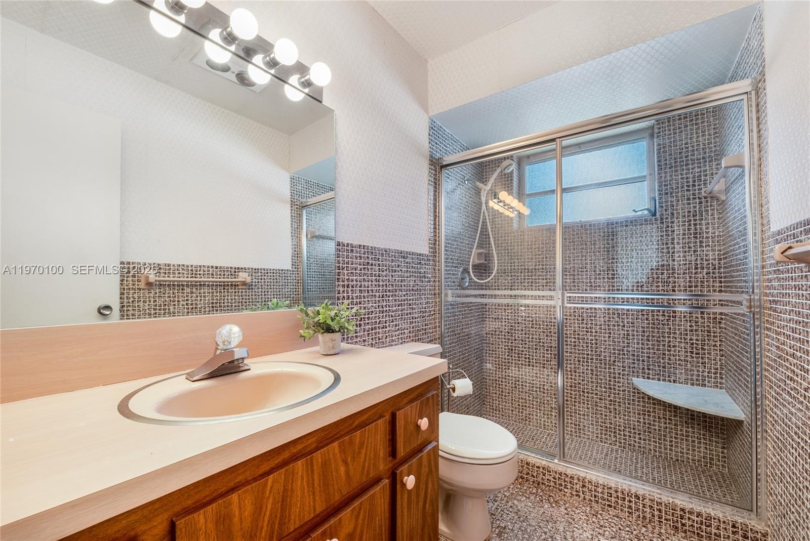 4931 Madison Street Hollywood, FL 33021 - Photo 21 of 26 a bathroom with a sink toilet and shower