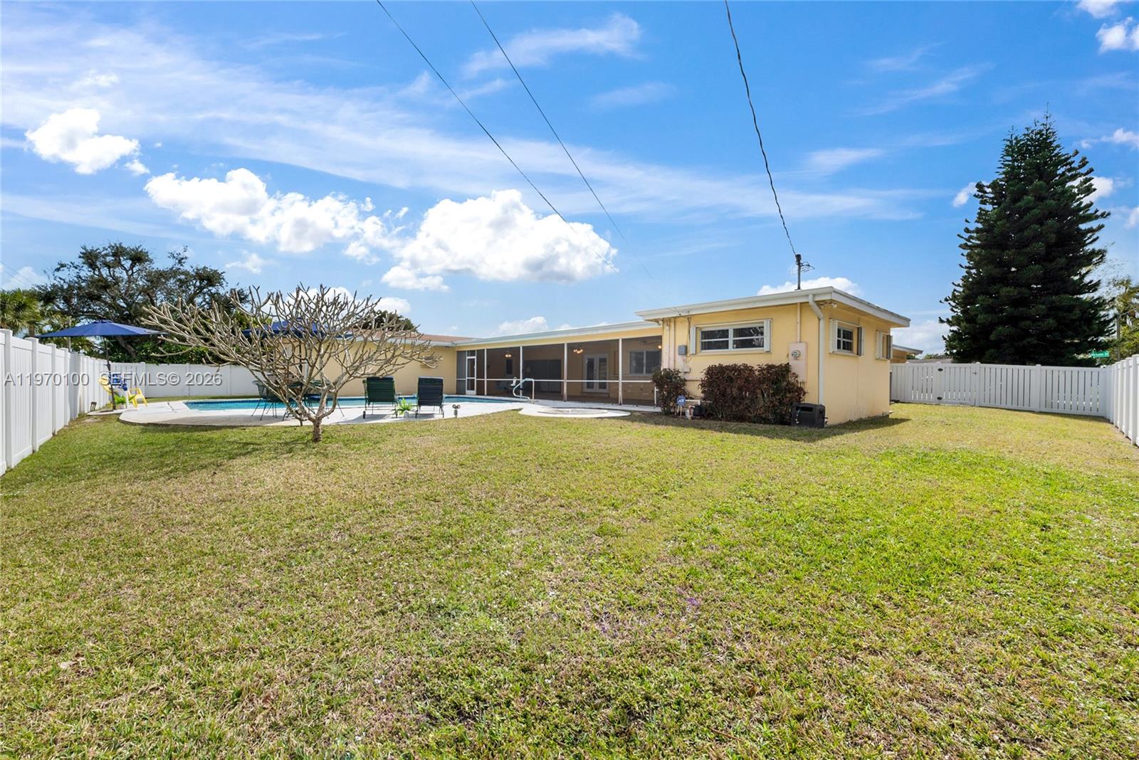 4931 Madison Street Hollywood, FL 33021 - Photo 24 of 26 a front view of a house with a yard