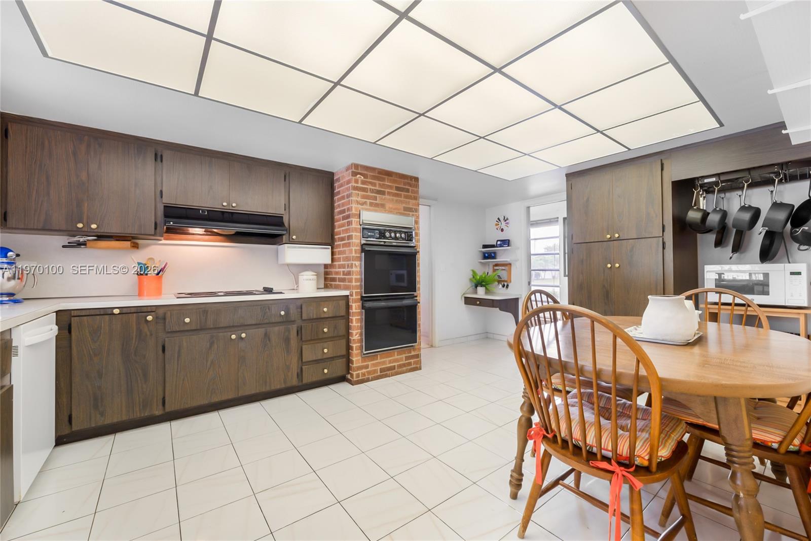 4931 Madison Street Hollywood, FL 33021 - Photo 10 of 26 a kitchen with stainless steel appliances kitchen island granite countertop a sink cabinets and microwave