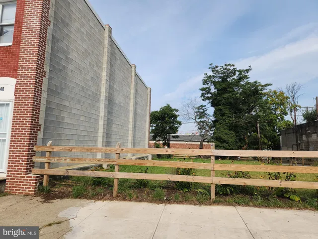 a view of swimming pool with outdoor seating and trees in the background