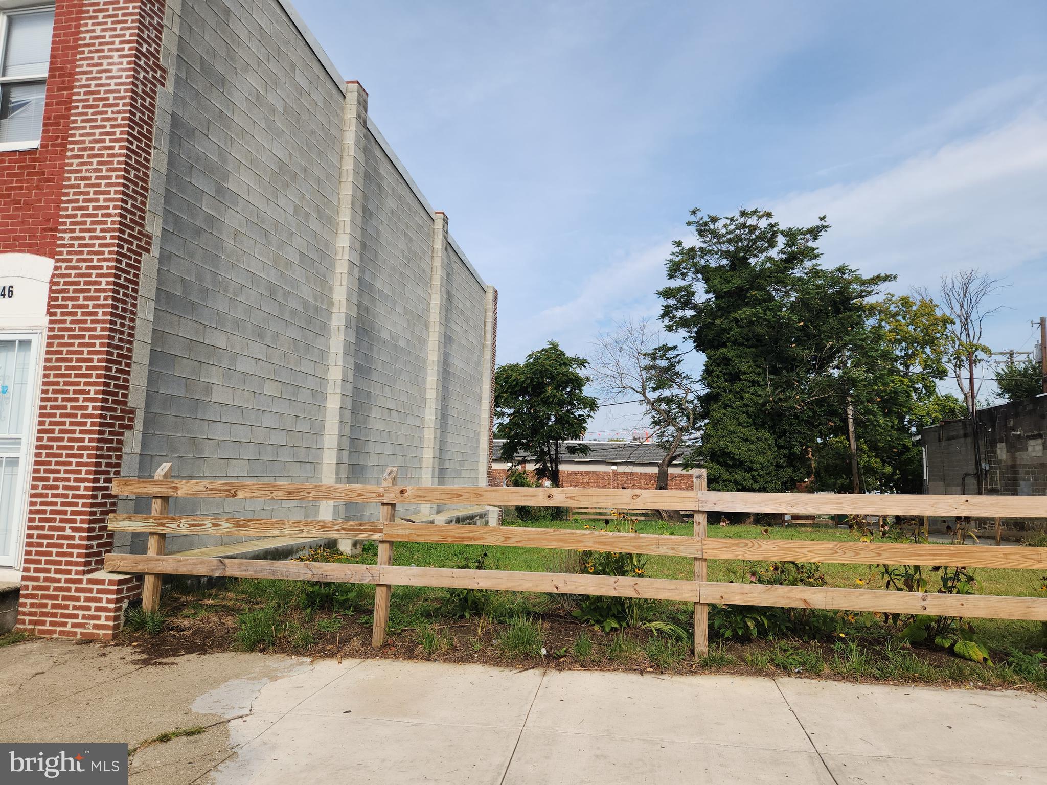 3644 South Hanover Street Baltimore, MD 21225 - Photo 2 of 6 a view of swimming pool with outdoor seating and trees in the background