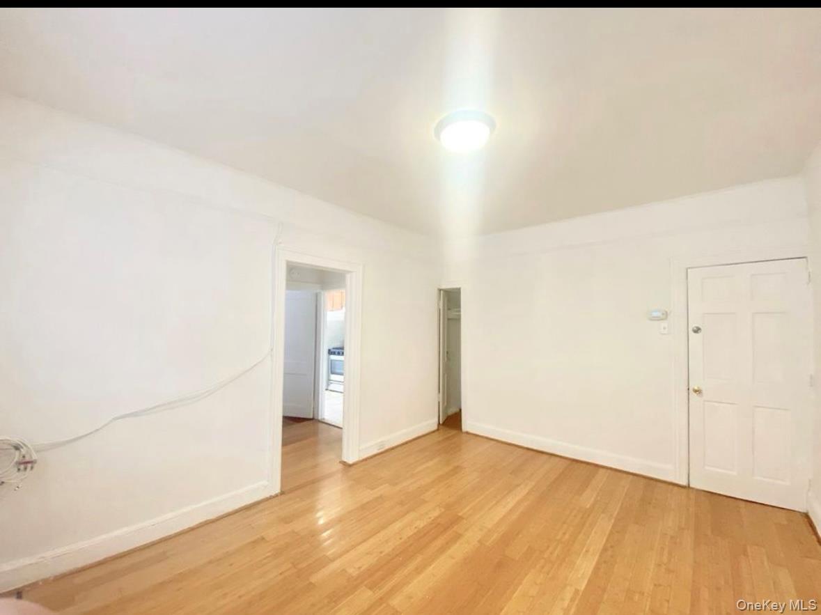 50-24 39th Place Queens, NY 11104 - Photo 4 of 10 Empty room featuring light wood-type flooring
