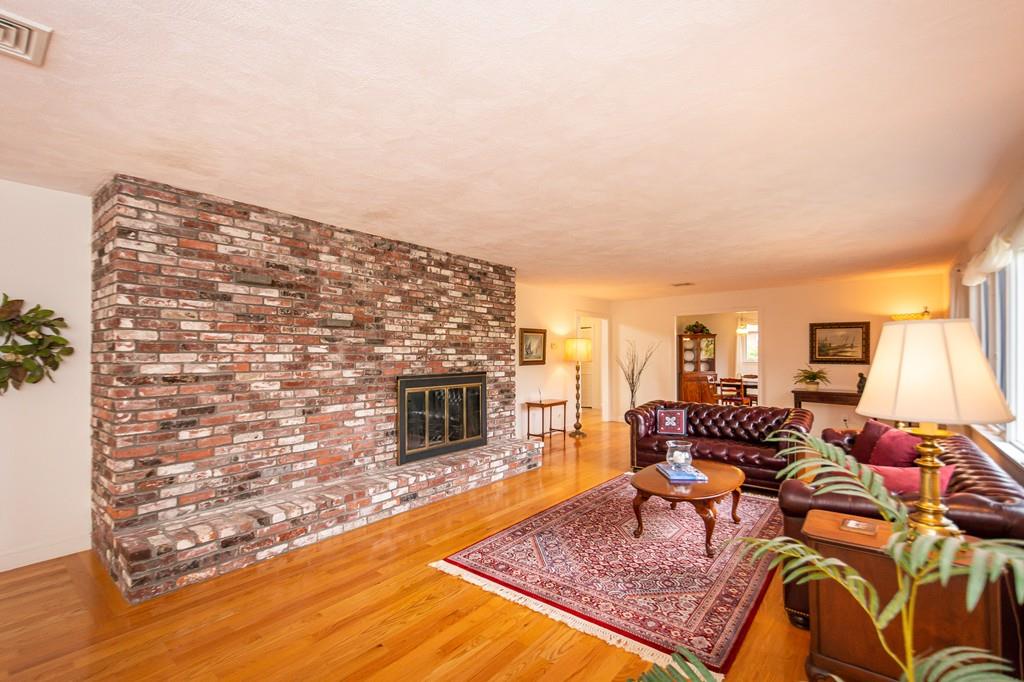 33 Windy Hill Road Cohasset, MA 02025 - Photo 11 of 42 a living room with furniture a rug and a fireplace