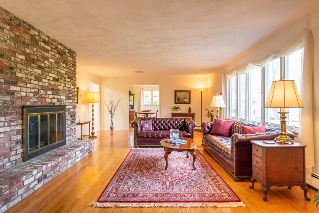 33 Windy Hill Road Cohasset, MA 02025 - Photo 12 of 42 a living room with furniture rug and a fireplace