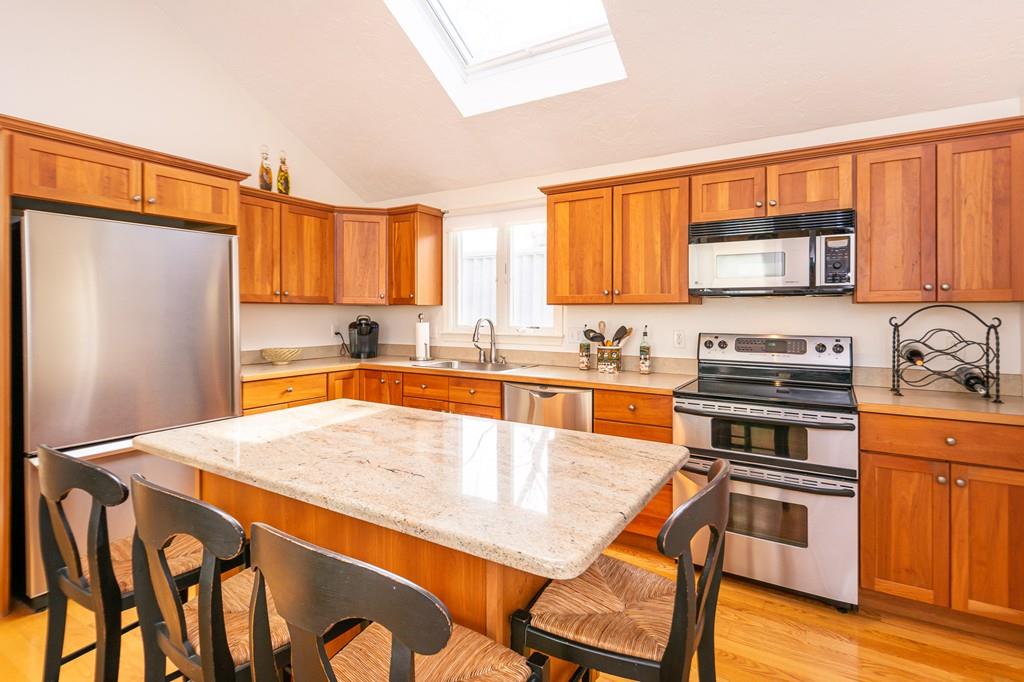 33 Windy Hill Road Cohasset, MA 02025 - Photo 19 of 42 a kitchen with stainless steel appliances granite countertop a stove top oven a sink and a refrigerator