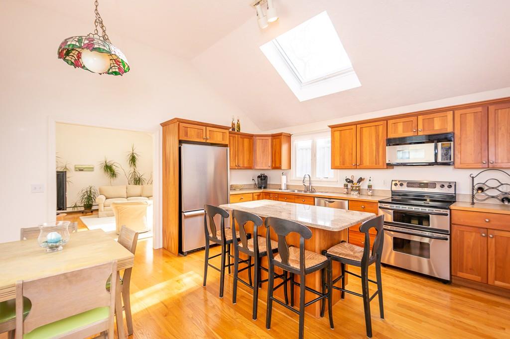33 Windy Hill Road Cohasset, MA 02025 - Photo 20 of 42 a kitchen with stainless steel appliances a stove a sink dishwasher and a refrigerator with wooden floor