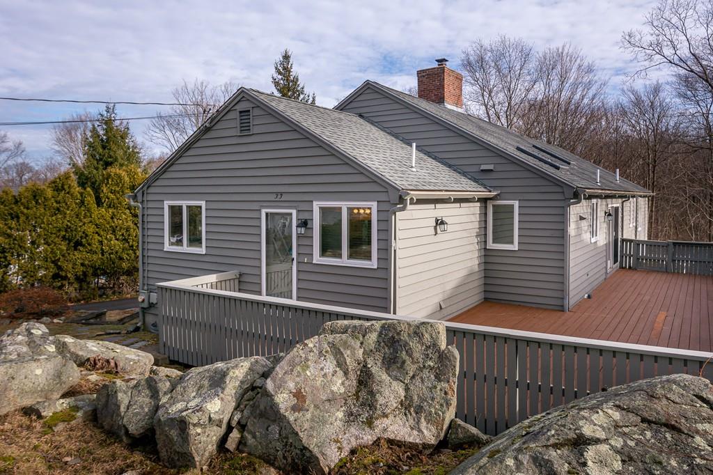 33 Windy Hill Road Cohasset, MA 02025 - Photo 2 of 42 a view of backyard with large trees and wooden fence
