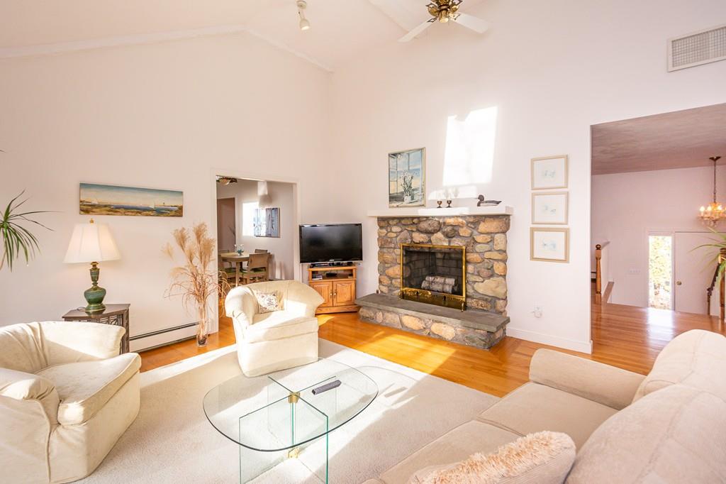 33 Windy Hill Road Cohasset, MA 02025 - Photo 22 of 42 a living room with furniture a fireplace and a flat screen tv