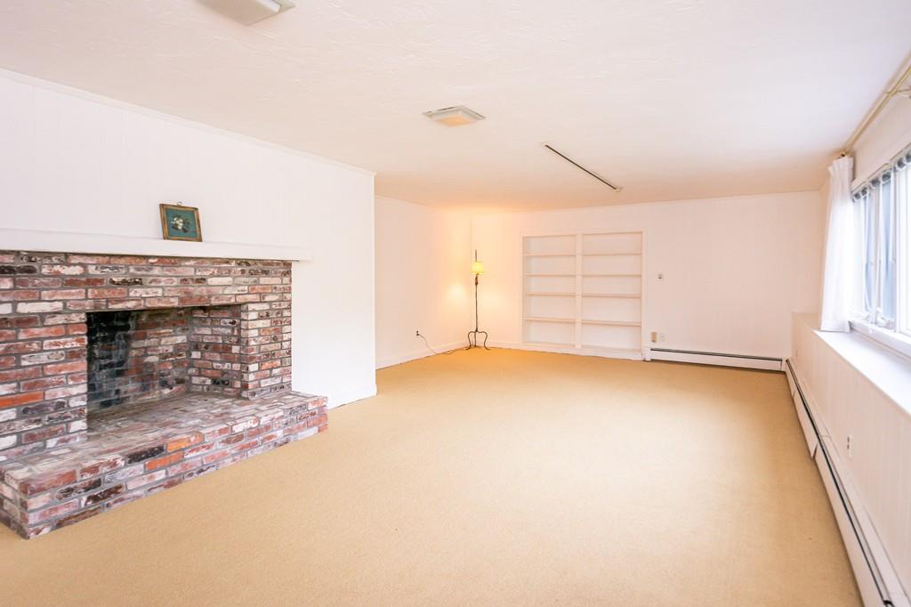 33 Windy Hill Road Cohasset, MA 02025 - Photo 34 of 42 an empty room with windows and fireplace