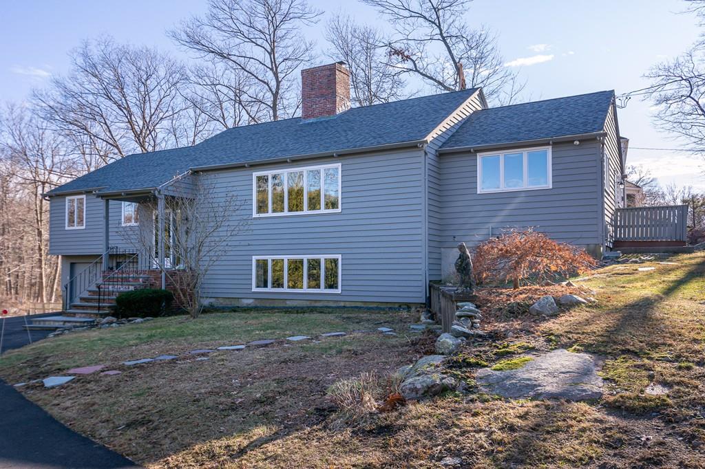 33 Windy Hill Road Cohasset, MA 02025 - Photo 5 of 42 a view of a brick house next to a yard